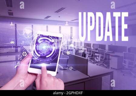 Conceptual display UPDATE. Business concept make something more modern or up to date like software program Laptop Resting On Lap Of Woman With Cross Stock Photo