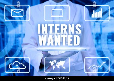 Text sign showing Interns Wanted. Word for Looking for on the job trainee Part time Working student Lady Uniform Standing Tablet Hand Presenting Stock Photo