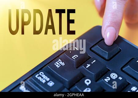 Inspiration showing sign UPDATE. Business idea make something more modern or up to date like software program Hands pointing pressing computer Stock Photo