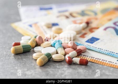 Euro banknotes and pills. Concept of healthcare. Stock Photo