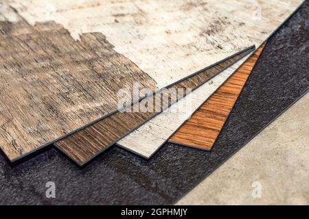 PVC vinyl floor. Samples of vinyl flooring. Collection of vinyl tiles. DIY home items Stock Photo