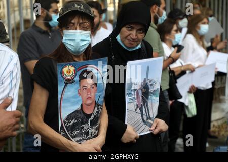 Beirut, Lebanon. 29th Sep, 2021. Relatives of the victims of the Beirut port blasts take part in a protest near the Justice Palace in Beirut, Lebanon, on Sept. 29, 2021. Hundreds of Lebanese, including families of victims killed in the deadly Beirut port blasts last year, demonstrated on Wednesday against the suspension of the investigation into the explosions, the National News Agency reported. Credit: Bilal Jawich/Xinhua/Alamy Live News Stock Photo