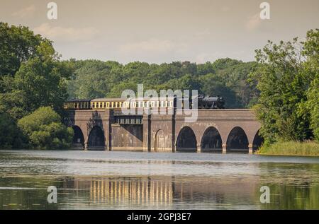 Steam train at Swithland reservoir on  The Great Central Railway (GCR) heritage line Stock Photo