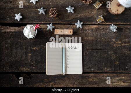 Top view of an open notebook with 2022 goal sign in it - conceptual image of new year resolutions. Stock Photo