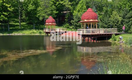 New Vrindaban Kusum Sarovara Lake and swan boat houses, , New Vrindaban, West Virginia, USA Stock Photo