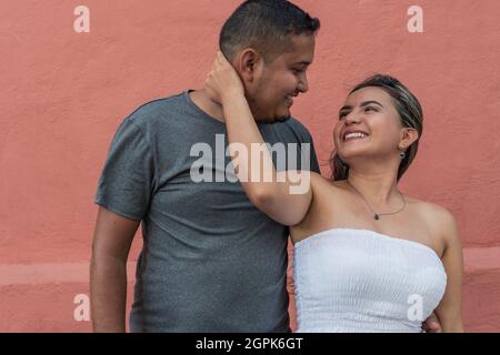 Hispanic couple looking at each other in the open air Stock Photo