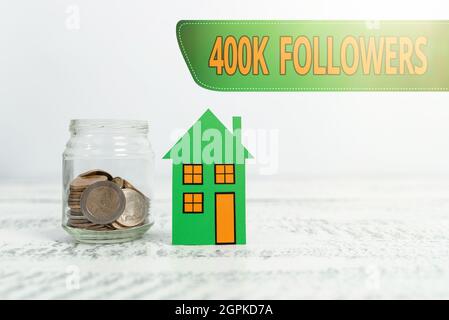 Hand writing sign 400K Followers. Internet Concept number of individuals who follows someone in Instagram Creating Property Contract To Sell Stock Photo