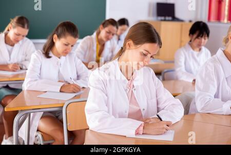 Medical students writing in notepads Stock Photo