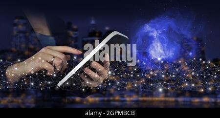 AI, Machine learning. Hand touch white tablet with digital hologram Artificial intelligence sign on city dark blurred background. Global database and Stock Photo