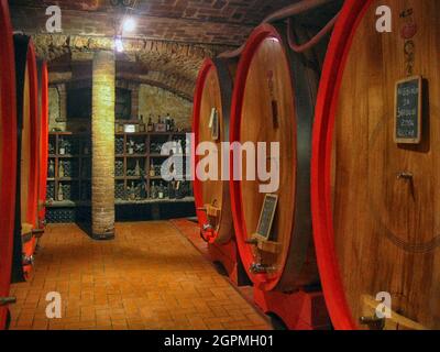 Oak wine casks in cellar of Italian wine maker Stock Photo