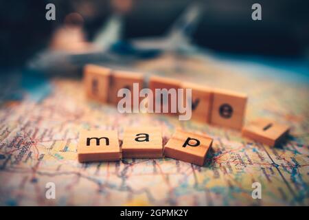 Wood square with word "map" and "travel" on the map. Travel plan concept. Stock Photo