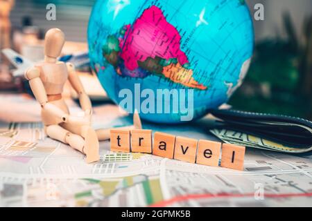 Wood square with word "travel" on the map. travel plan concept. Stock Photo