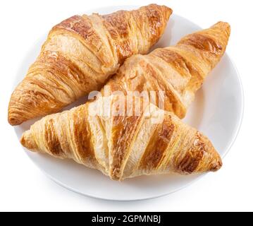 Tasty crusty croissants on the plate on white background. Top view. File contains clipping path. Stock Photo