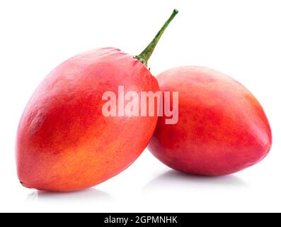 Two ripe tamarillo fruits isolated on a white background. Stock Photo