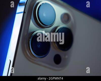 Rear view of triple improved camera array on iPhone 13 Pro at the Apple Store as latest new 5G iPhone new iPad and iPad mini go on sale Stock Photo