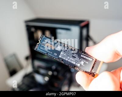 OV male hand holding new powerful NVME 970 Evo Plus V-Nand SSD by Samsung electronic Stock Photo