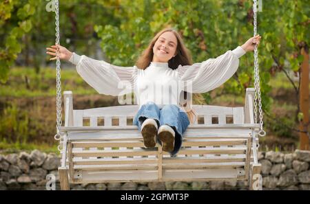 happy child swinging on swing outdoor, summer Stock Photo