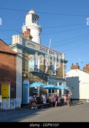 Enjoying a summer evening at the Adnams Brewery Sole Bay Inn seaside town of Southwold on the Suffolk Heritage Coast in East Suffolk England UK Stock Photo