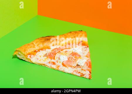 Pizza with Mozzarella cheese, salmon fish. Italian pizza on green paper background Stock Photo