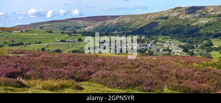 Reeth Panoramic view of the village of Reeth, from Grinton moor with heather ...