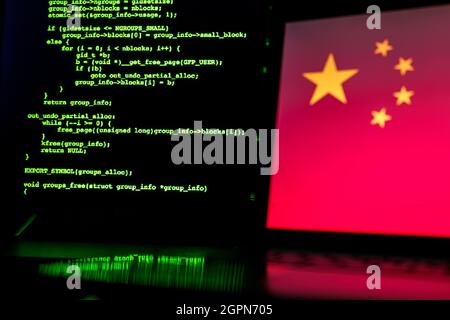 Chinese anonymous hackers. China flag and programming code in background Stock Photo