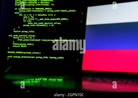 Russian anonymous hackers. Russian flag and programming code in background Stock Photo
