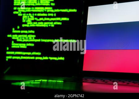 Russian anonymous hackers. Russian flag and programming code in background Stock Photo