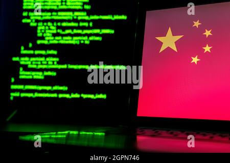 Chinese anonymous hackers. China flag and programming code in background Stock Photo