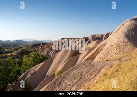 beautiful sunset landscape with typical geological soft rock formations pattern in Cappadocia plateau Turkey Stock Photo