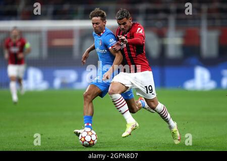Theo Hernandez of Ac Milan  and Marcos Llorente of Club Atletico de Madrid battle for the ball during the Uefa Champions League Group B  match between Ac Milan and Club Atletico de Madrid at Stadio Giuseppe Meazza on September 28, 2021 in Milan, Italy . Stock Photo