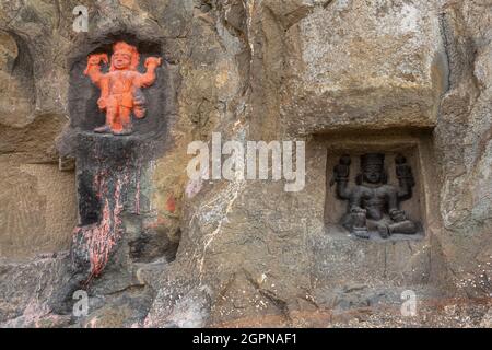 Carved statues of Gods on the rock of Mangi Tungi hills. Nashik, Maharashtra, India. Stock Photo