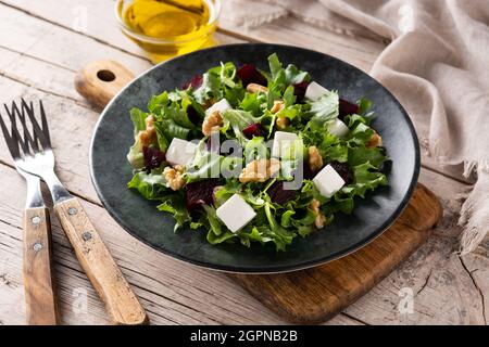 Beetroot salad with feta cheese,lettuce and walnuts on wooden table Stock Photo