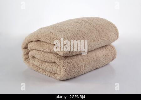 Soft and warm of brown folded blanket isolated on white background Stock Photo