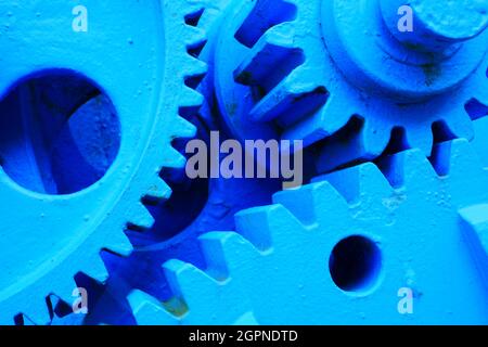 close up of three blue painted metal gears of a dam Stock Photo