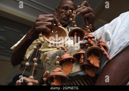 Indian potters give shape to earthenware at their  workshop in potters village in New Delhi. Potters village is situated in New Delhi's Uttam Nagar. Stock Photo