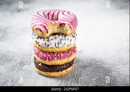 Stack of artisan donuts. White background. Top view. Copy space Stock Photo