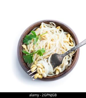 Marinated  sprouted mung beans in wooden bowl isolated on white