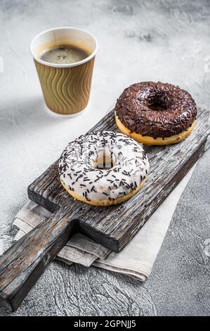Fresh Chocolate artisan donuts and take away coffee. White background. Top view Stock Photo