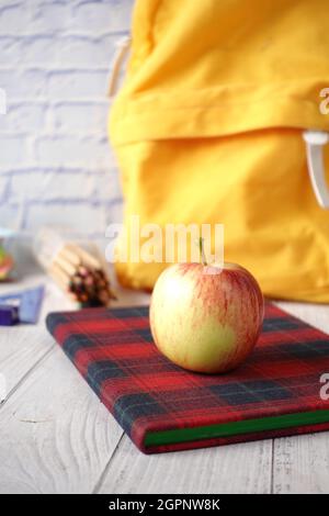 black to school concept with apple on notepad on table. Stock Photo