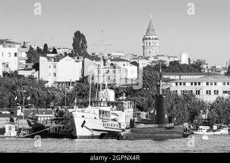 Istanbul, Turkey; May 26th 2013: Ship and submarine exhibited in the transport museum, with the Galata Tower in the background. Stock Photo