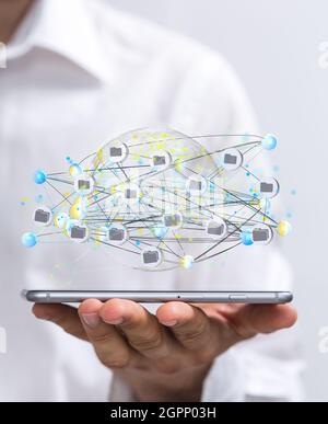 Vertical shot of a data cloud storage network above a smartphone Stock Photo