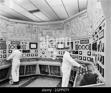 Two workers operating the electronic console panel at the Whitbread brewery. The photograph is part of a batch taken to show phase II of a contract carried out by the 'Construction Company' for Whitbread. Phase II which had started in October 1965 was in eight sections and included a stacking and warehouse area, a kegging hall, a maturation tank area, boilerhouse and engine room, a fermenter area, by-products area, brew hall, offices and laboratories Stock Photo