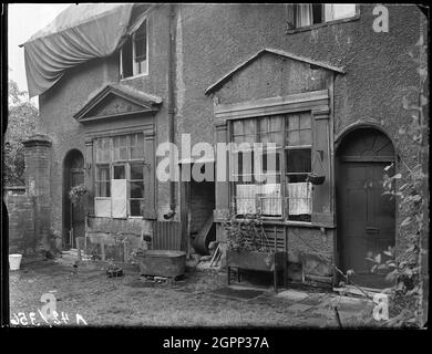 Court 20, Little Park Street, Coventry, 1941. The exterior of numbers 5 and 6, Court 20, accessed between 92 and 93 Little Park Street, showing the roof covered by tarpaulin. Coventry City centre was devastated by air raids in November 1940. The bombing left the cathedral in ruins and destroyed much of the historic fabric of the city. Court number 20 was situated to the rear of Little Park Street which suffered significant damage in the aerial bombardment. Much of the street was demolished in the years following the war. The Magistrates Court now occupies this site. Stock Photo