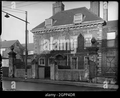 Bilston Street, Wolverhampton, Spring 1942. The front elevation of 19 Bilston Street. This building probably started life as a private town house in the late 17th or 18th century. By the latter part of the 19th century it was home to the Conservative Club and later served as offices for Samuel Cassin Pritchard &amp; Company Limited, Iron Streel and Mineral Merchants. The house was demolished and Wolverhampton Police Station now occupies the site. Stock Photo