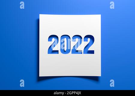 A piece of curved memo paper with the cut out number 2022 on blue background. Concept for events in the year 2022 and New Year 2022. Stock Photo