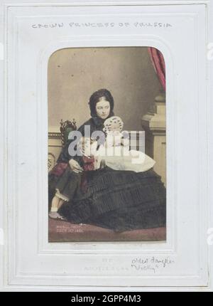 The Crown Princess of Prussia, 1861. [Portrait of Victoria, eldest daughter of Queen Victoria and wife of Frederick, Crown Prince of Prussia. On the left is her son the future German emperor Wilhelm II, with his sister Princess Charlotte, on her mother's lap]. Albumen print with applied colouring. Stock Photo