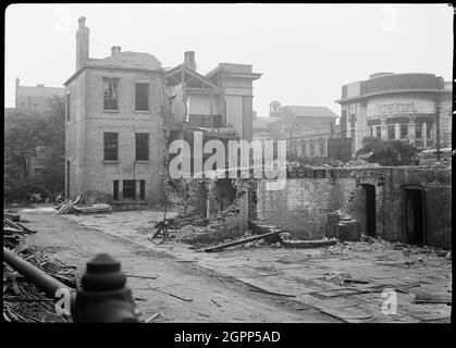 Master Mariners Almshouse, Carr Lane, City of Kingston Upon Hull, 1941. An exterior view of the Master Mariner's Almshouses, damaged in an air raid in 1941, seen from the east with the former Cecil Theatre in the background. The almshouses consisted of two blocks; the first was the Master Mariner's Almshouse, built in 1834, and the second was the Mariners Almshouse, built in 1837. Both blocks were built for the Corporation of the Trinity House and housed retired and ill seamen and their families. The almshouses were damaged in 1941 by bombs, and were demolished post-war. The Theatre in the bac Stock Photo