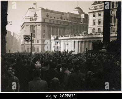National Westminster Bank, Prince's Street, City and County of the City of London, Greater London Authority, 1952. A view from Cornhill towards the National Westminster Bank, looking over crowds gathered outside the Royal Exchange and on rooftops of nearby buildings and the Bank of England, for the public proclamation of Queen Elizabeth II at the Royal Exchange. Princess Elizabeth was formally proclaimed Queen on 8th February 1952, following the death of her father, George VI, on 6th February. An accession proclamation was published in the London Gazette on 6th February and in The Times on 7th Stock Photo