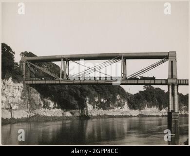 Chepstow Rail Bridge, Tidenham, Forest of Dean, Gloucestershire, 1951. The eastern section of Chepstow Rail Bridge, viewed from the north-west, with a train travelling across the bridge. The Chepstow Rail Bridge was designed by Isambard Kingdom Brunel and was completed in 1852. It was also known as the 'Great Tubular Bridge'. The bridge was superseded by a new bridge constructed in 1962, though the tubular iron supports of the original bridge remain. Stock Photo