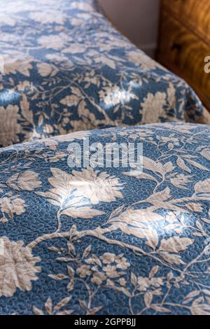 1920’s vermicelli  floral bedcover in Suffolk cottage Stock Photo